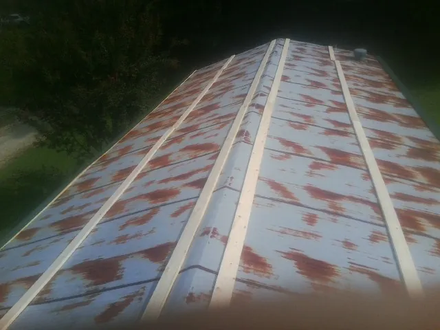 Rusted metal roof panels with new wood purlins before replacement — Storm Damage Roof Repair in White Salmon by Roofing Brothers